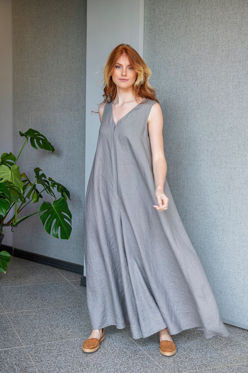 Our linen jumpsuit dress will win many hearts for the balance of elegance and comfort at every step. A wide legged piece that is very suitable for the hot summer days with its breezy, yet elegant and flowy design.