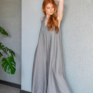 Our linen jumpsuit dress will win many hearts for the balance of elegance and comfort at every step. A wide legged piece that is very suitable for the hot summer days with its breezy, yet elegant and flowy design.