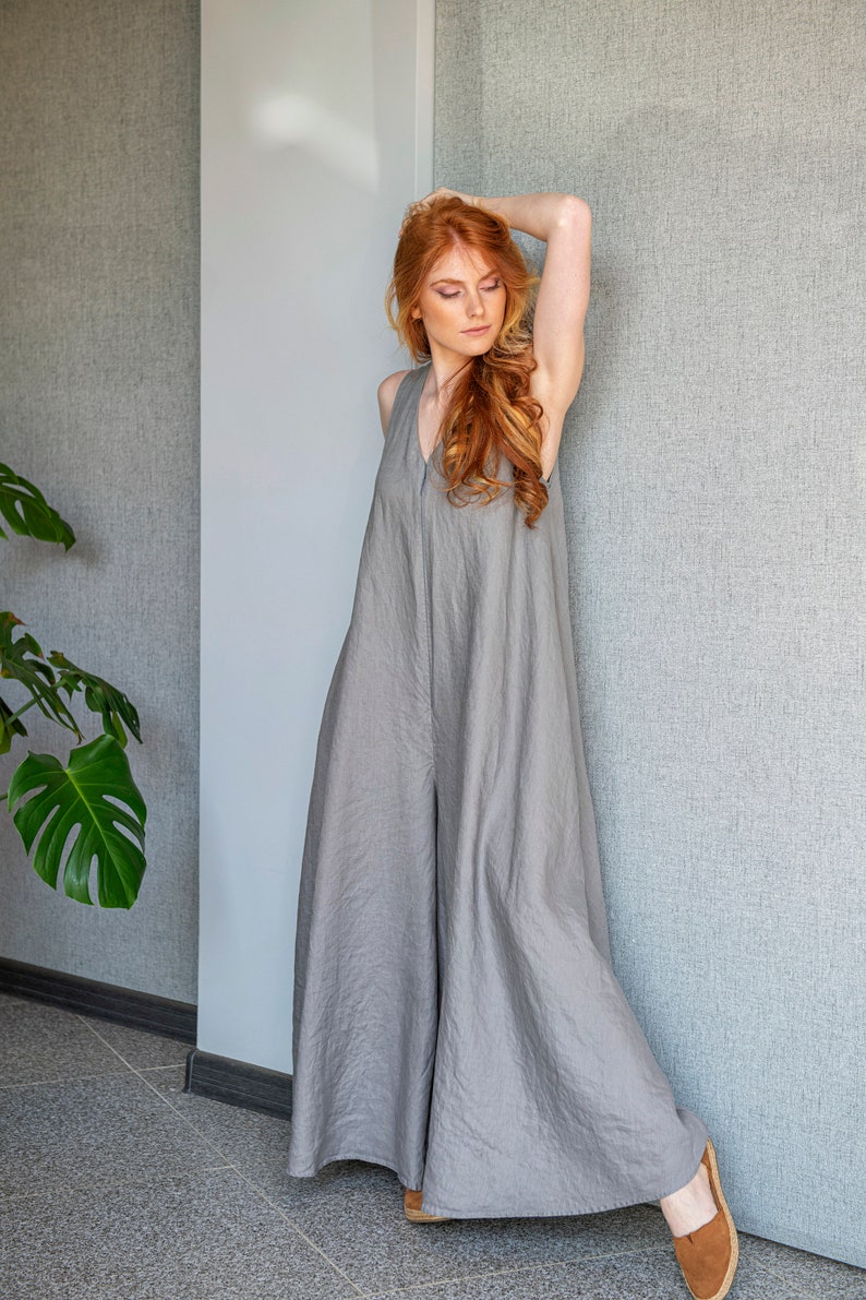 Our linen jumpsuit dress will win many hearts for the balance of elegance and comfort at every step. A wide legged piece that is very suitable for the hot summer days with its breezy, yet elegant and flowy design.