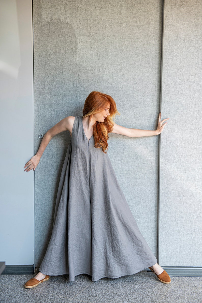 Our linen jumpsuit dress will win many hearts for the balance of elegance and comfort at every step. A wide legged piece that is very suitable for the hot summer days with its breezy, yet elegant and flowy design.