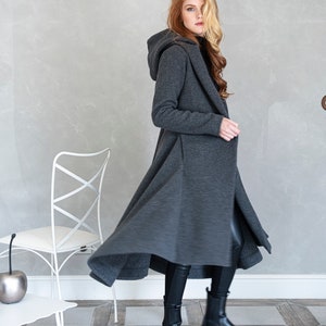 Gorgeous, warm and originally designed, this merino wool coat will be your darling for the chilly days. Featuring an asymmetric hem, oversize hood and side pockets, this jacket hugs the body at all the right parts and makes you look fabulous