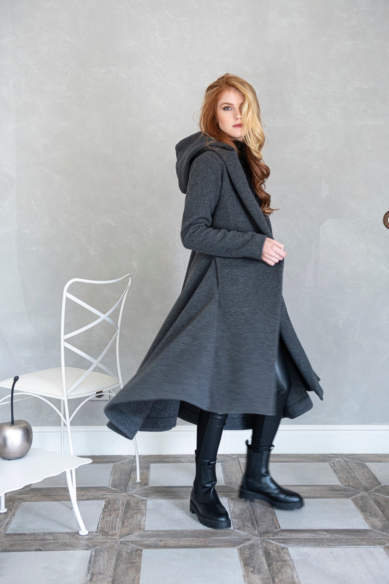 Gorgeous, warm and originally designed, this merino wool coat will be your darling for the chilly days. Featuring an asymmetric hem, oversize hood and side pockets, this jacket hugs the body at all the right parts and makes you look fabulous