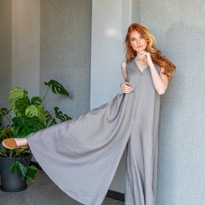 Our linen jumpsuit dress will win many hearts for the balance of elegance and comfort at every step. A wide legged piece that is very suitable for the hot summer days with its breezy, yet elegant and flowy design.