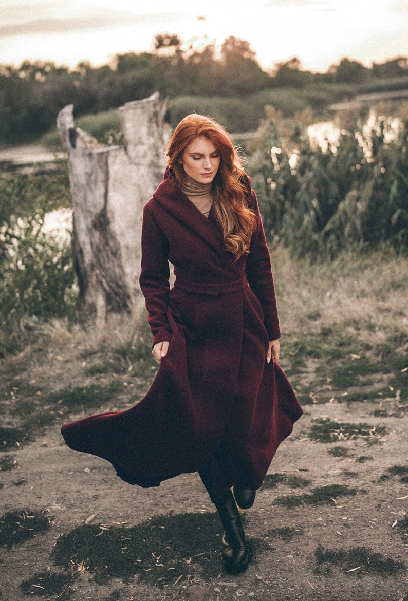 This winter coat is the perfect mix between boho and elegant. It has a beautiful silhouette with a tie waist and rich skirt, while the slouchy hood, hidden buttons and side pockets lend functionality.