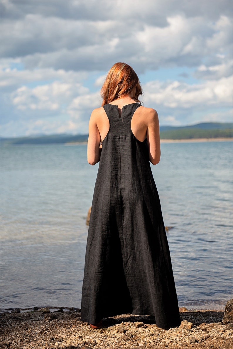 Sleeveless minimalist dress - perfect match for bold jewelry. Long and soft, this maxi dress is made of pure linen that is breathable and pleasant to your body. The elongated cut and halter back create a beautiful silhouette that will turn heads