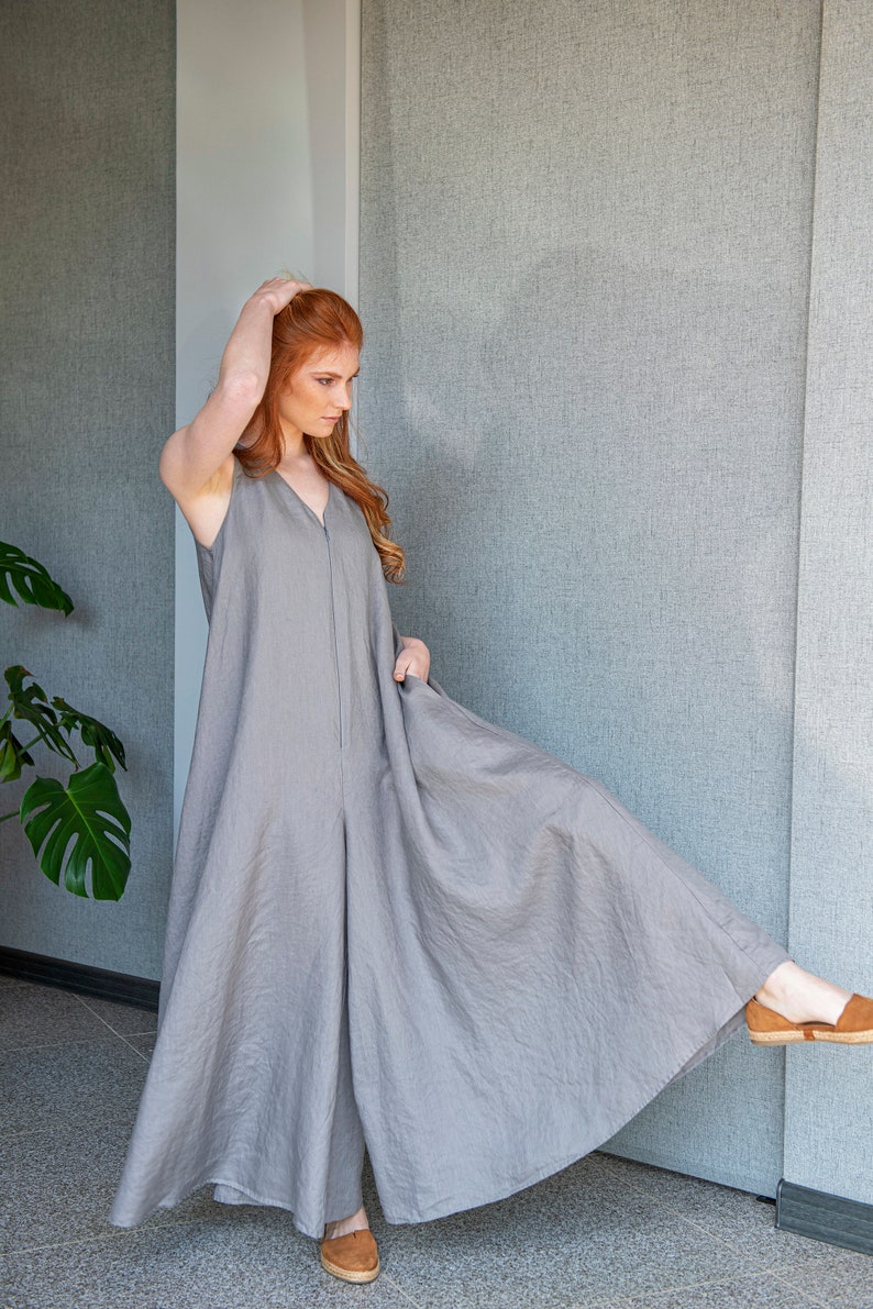 Our linen jumpsuit dress will win many hearts for the balance of elegance and comfort at every step. A wide legged piece that is very suitable for the hot summer days with its breezy, yet elegant and flowy design.