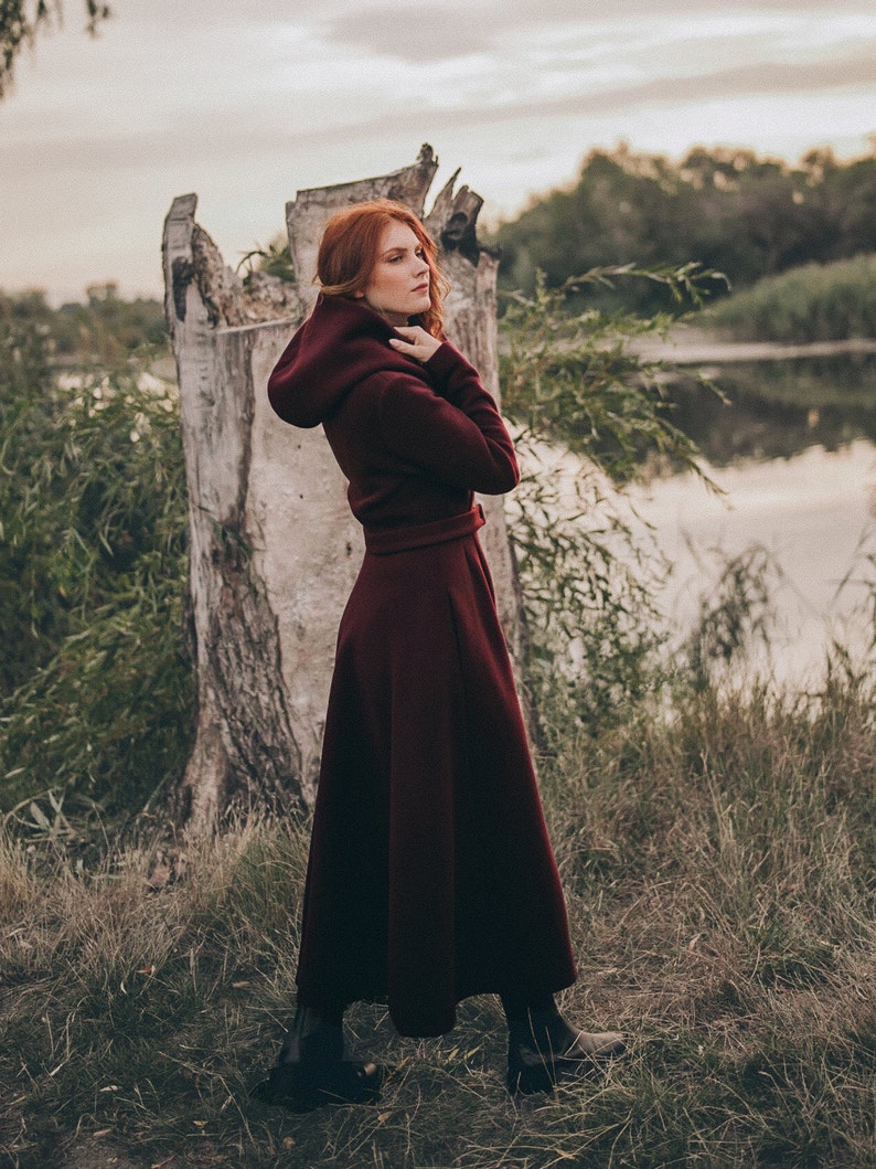 This winter coat is the perfect mix between boho and elegant. It has a beautiful silhouette with a tie waist and rich skirt, while the slouchy hood, hidden buttons and side pockets lend functionality.