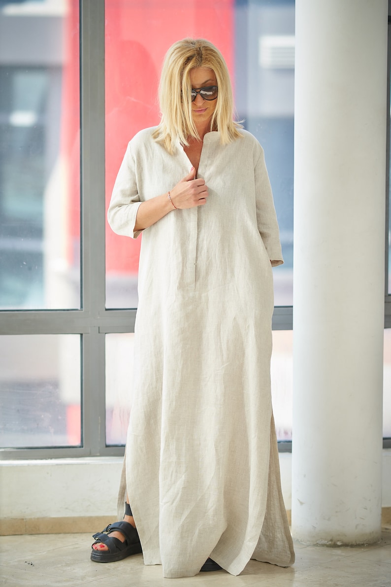 Long kaftan dress made from high quality 100% linen material. This stylish yet bohemian dress has a straight loose line, split neckline with button closure, elbow length sleeves and side slits.