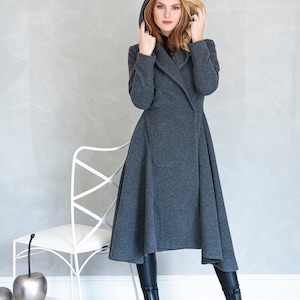 Gorgeous, warm and originally designed, this merino wool coat will be your darling for the chilly days. Featuring an asymmetric hem, oversize hood and side pockets, this jacket hugs the body at all the right parts and makes you look fabulous.