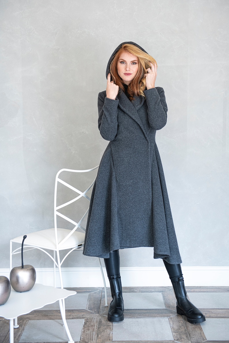 Gorgeous, warm and originally designed, this merino wool coat will be your darling for the chilly days. Featuring an asymmetric hem, oversize hood and side pockets, this jacket hugs the body at all the right parts and makes you look fabulous.