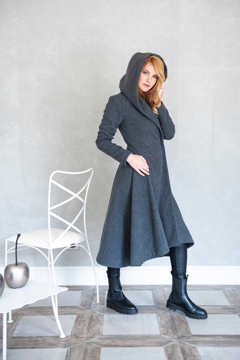 Gorgeous, warm and originally designed, this merino wool coat will be your darling for the chilly days. Featuring an asymmetric hem, oversize hood and side pockets, this jacket hugs the body at all the right parts and makes you look fabulous.