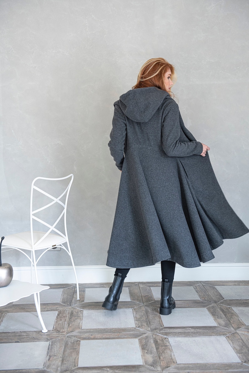 Gorgeous, warm and originally designed, this merino wool coat will be your darling for the chilly days. Featuring an asymmetric hem, oversize hood and side pockets, this jacket hugs the body at all the right parts and makes you look fabulous.