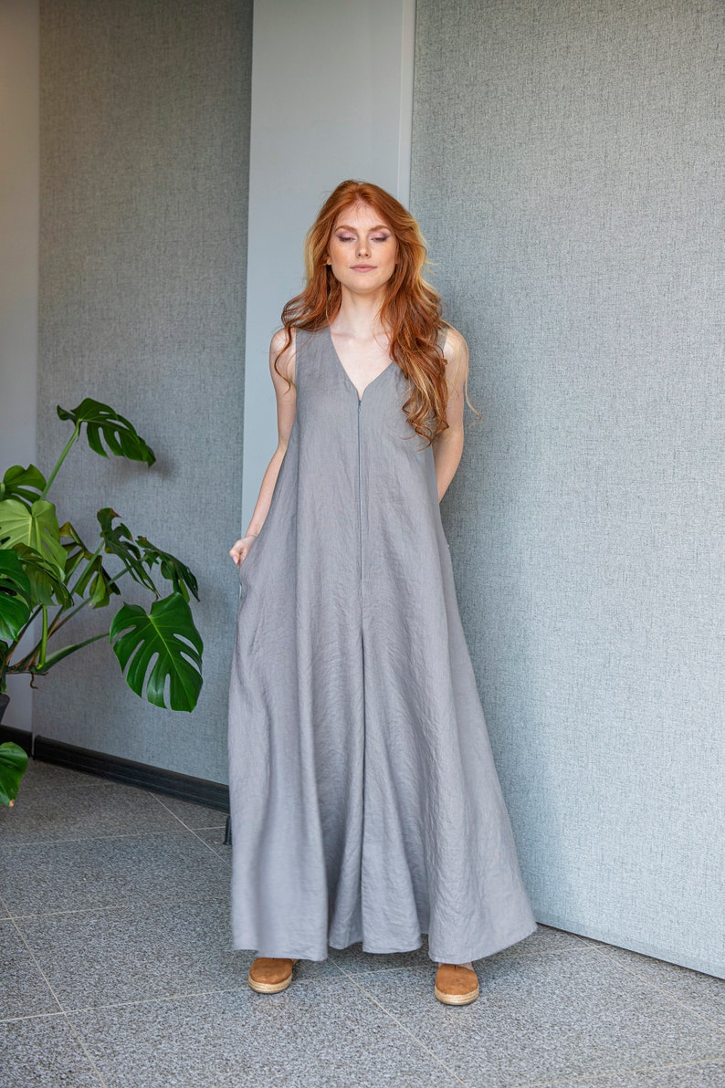 Our linen jumpsuit dress will win many hearts for the balance of elegance and comfort at every step. A wide legged piece that is very suitable for the hot summer days with its breezy, yet elegant and flowy design.