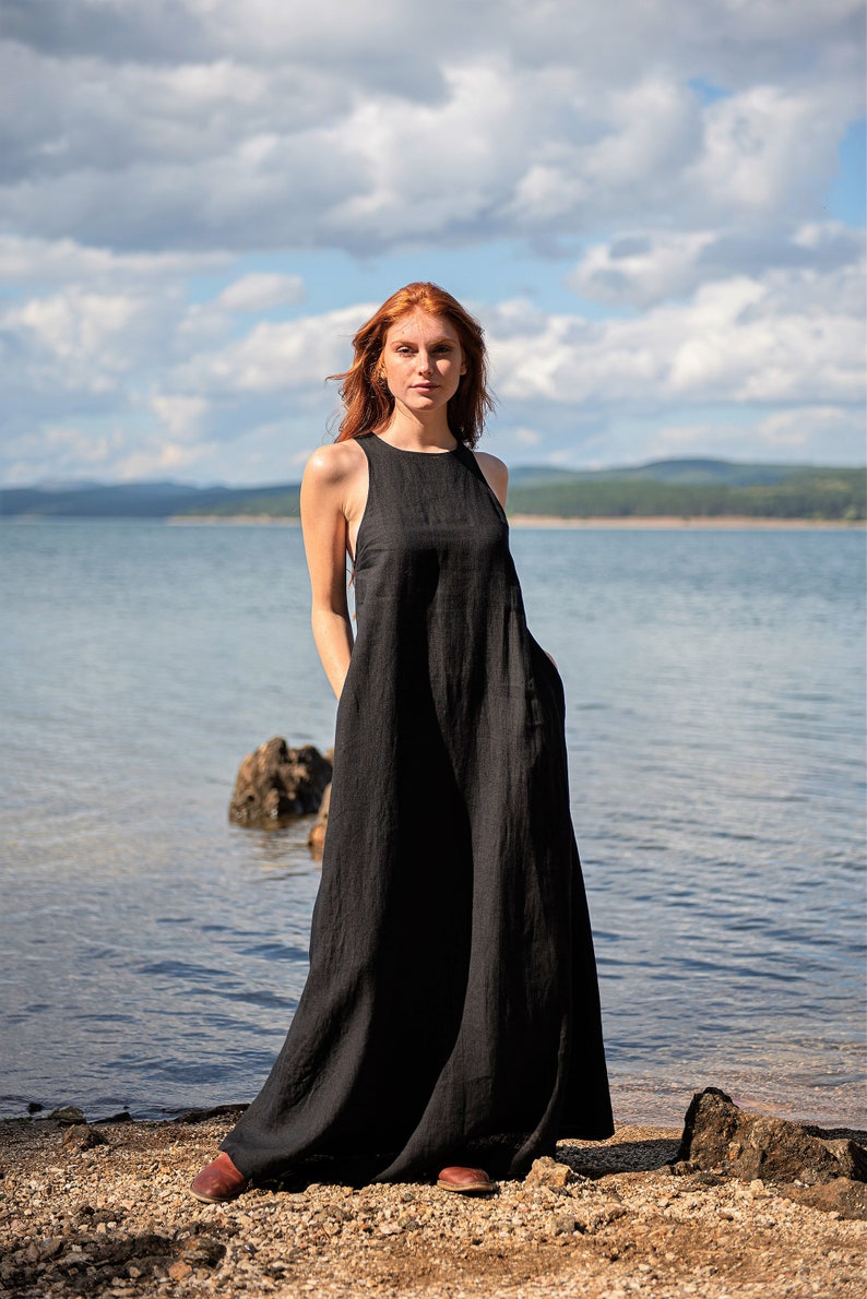 Sleeveless minimalist dress - perfect match for bold jewelry. Long and soft, this maxi dress is made of pure linen that is breathable and pleasant to your body. The elongated cut and halter back create a beautiful silhouette that will turn heads