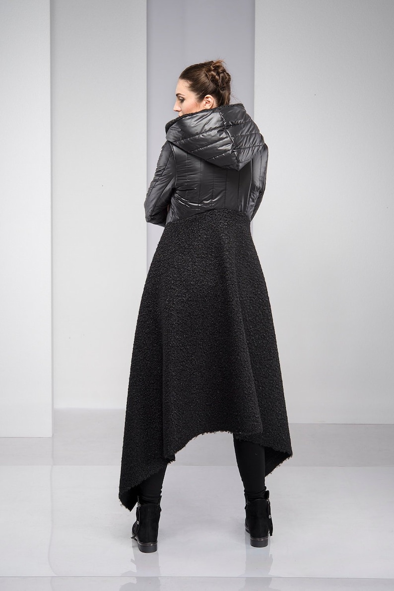 Stylish, fun and warm, this asymmetric jacket with padded detailing will get you compliments all the time! Featuring an oversized hood, button down closure and a silhouette that emphasizes the waist, this coat is both feminine and edgy.