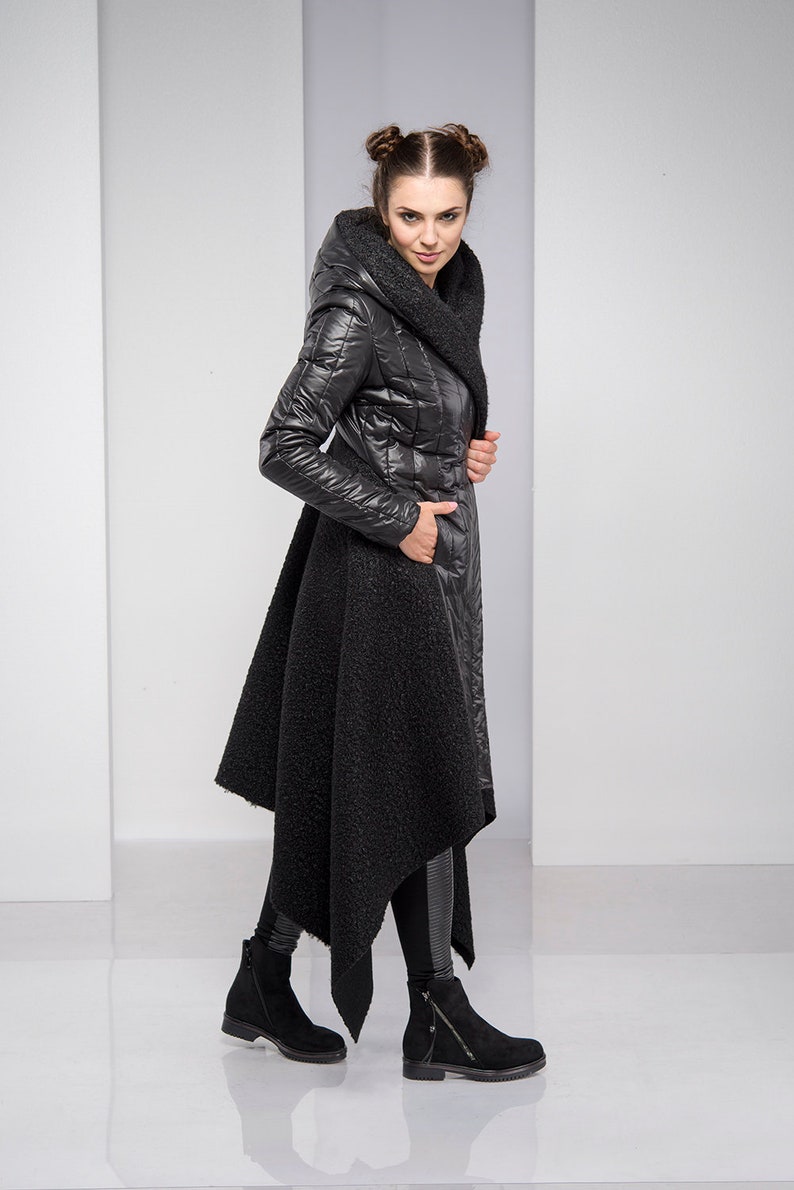 Stylish, fun and warm, this asymmetric jacket with padded detailing will get you compliments all the time! Featuring an oversized hood, button down closure and a silhouette that emphasizes the waist, this coat is both feminine and edgy.