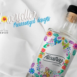 May include: A clear glass bottle with a black cap and a colorful floral label. The label features a wreath of flowers, birds, and the text "Alcatraz Ginebra".