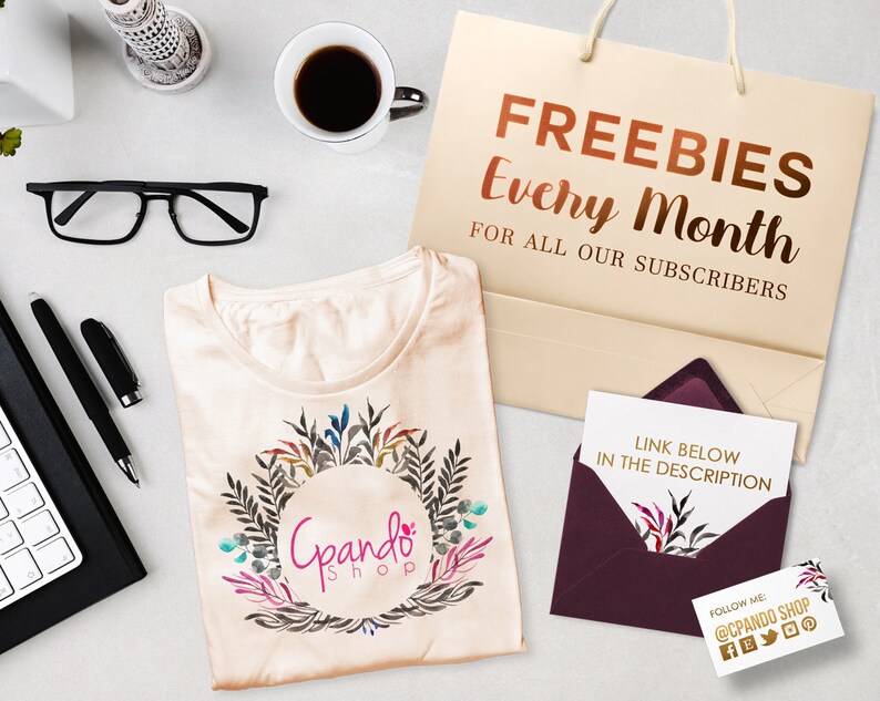 May include: A beige t-shirt with a floral wreath design and the text "Gpando Shop" in a circle. A brown paper bag with the text "FREEBIES Every Month FOR ALL OUR SUBSCRIBERS". A burgundy envelope with a white card inside that says "LINK BELOW IN THE DESCRIPTION". A business card with the text "FOLLOW ME @CPANDO SHOP" and social media icons.