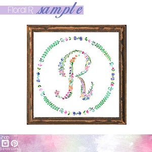 May include: A watercolour painting of the letter R surrounded by a wreath of flowers. The letter is made up of flowers in shades of pink, purple, blue, and yellow. The wreath is made up of green leaves and small flowers.