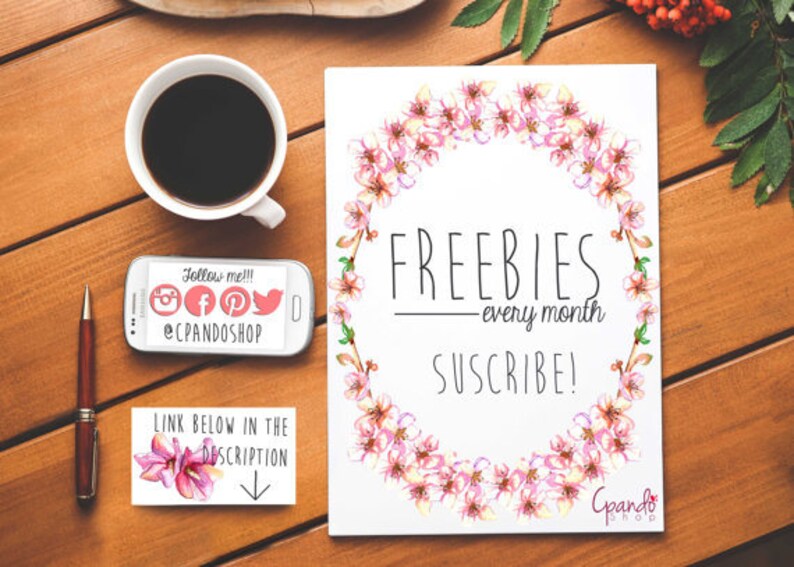 May include: A white card with a pink floral wreath border. The text "FREEBIES - every month SUSCRIBE!" is in black text. The text "Follow me!!! @CPANDOSHOP" is on a white phone. The text "LINK BELOW IN THE DESCRIPTION" is on a white card with a pink flower.