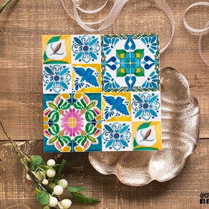 May include: A colorful tile design with blue, yellow, green, pink, and white colors. The tile design features birds, flowers, and geometric patterns.