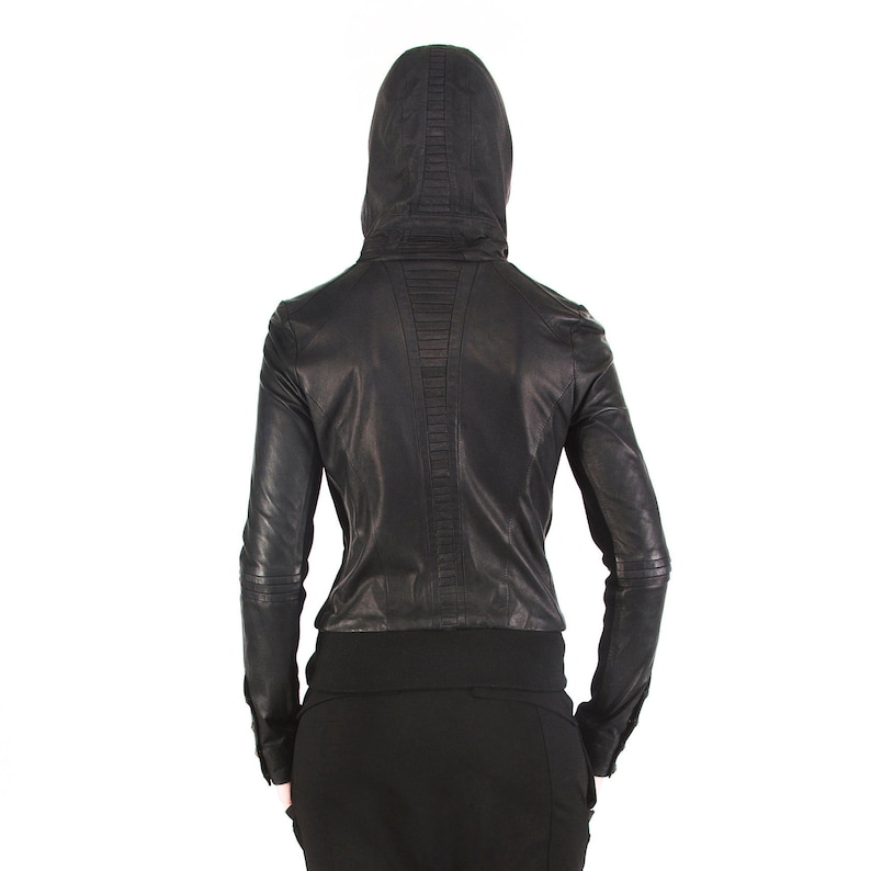 May include: Black leather jacket with a hood and zipper closure. The jacket has a quilted design on the back.