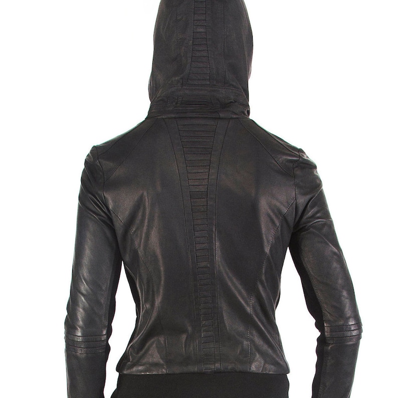 May include: Black leather jacket with a hood and a zipper closure. The jacket has a quilted design on the back.