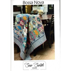 May include: A colorful quilt pattern called "Bossa Nova" by Sew Swish Designs. The quilt is made with a variety of fabrics in shades of pink, blue, green, yellow, and red. The quilt is folded and draped over a chair.