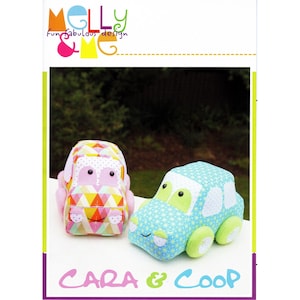 May include: Two soft toy cars, one pink and yellow with a geometric pattern, the other blue with a star pattern. The cars have smiling faces and are labelled "Cara & Coop" with the "Molly & LMG" logo.
