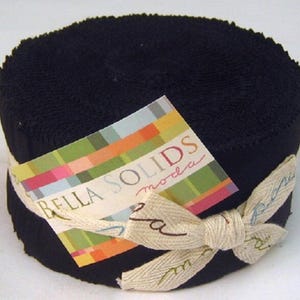 Op de afbeelding: Een rol zwarte stof, strak opgerold en vastgezet met een crèmekleurig lint dat in een strik is geknoopt. Een kleurrijk label met de woorden "BELLA SOLIDS moda" is bevestigd. De stof lijkt katoen of een vergelijkbaar materiaal te zijn.