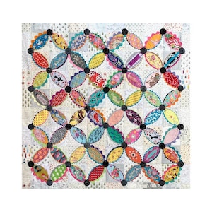 May include: A colorful handmade quilt with a repeating pattern of oval shapes connected by black circles. The ovals feature various patterned fabrics in shades of red, blue, yellow, and green. The background is a light, patterned fabric.