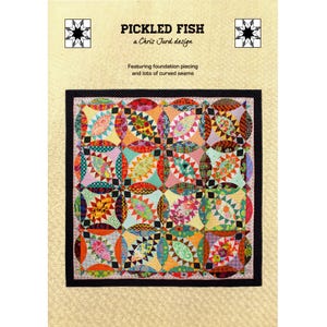May include: A colorful quilt with a black border, featuring a repeating pattern of circles and squares in various colors. The quilt is labeled "PICKLED FISH" by Chris Jurd, with text indicating foundation piecing and curved seams.