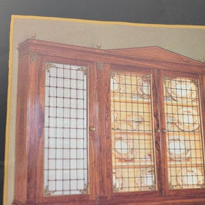 May include: A large wooden cabinet with glass doors and a grid pattern. The cabinet is filled with plates and other dishes.