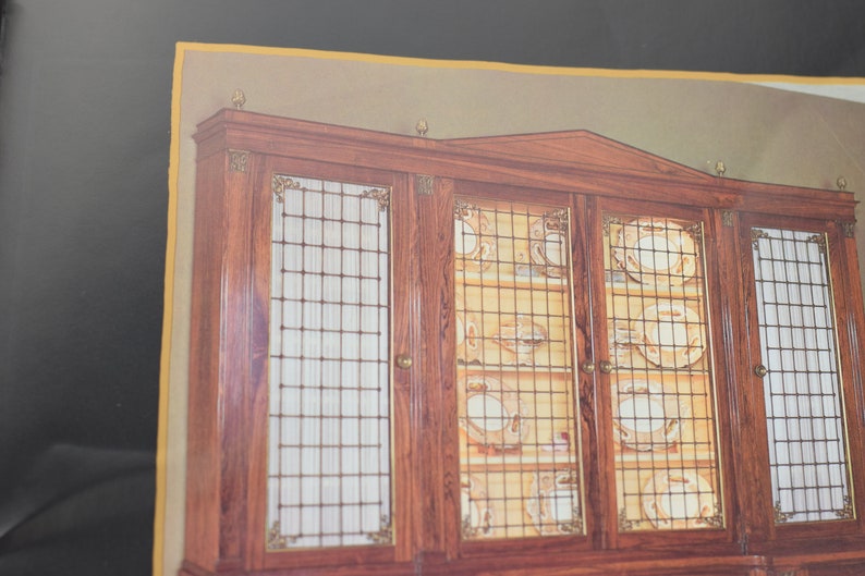 May include: A large wooden cabinet with glass doors and a grid pattern. The cabinet is filled with plates and other dishes.