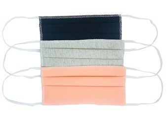 May include: Three reusable face masks, one black, one gray, and one peach. The masks are made of a soft, breathable fabric and have elastic ear loops.