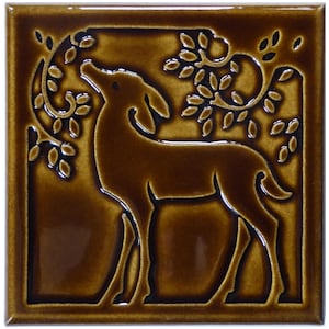May include: A square ceramic tile with a glossy dark brown finish featuring a raised relief design of a deer standing in profile. The deer is positioned beneath stylized tree branches with leaves, creating a textured, monochromatic surface.