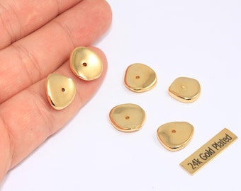 May include: Gold-plated jewelry findings in organic shapes. The findings have a hole for stringing and are displayed on a white surface. A small rectangular tag reads "24k Gold Plated".