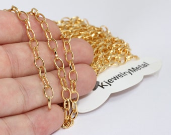 May include: Close-up of a gold-colored chain with oval links. The chain is displayed on a white background. A tag with the text "KjewelryMetal" is visible. The chain is likely used for jewelry making.