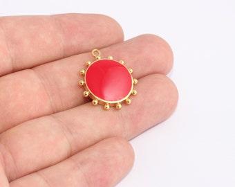 May include: A gold-colored pendant with a bright red center and a ring of small gold beads around the edge. The pendant has a small loop at the top for attaching to a chain or other jewelry component.