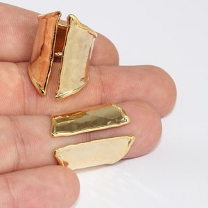 May include: Gold-toned jewelry findings in a variety of shapes. The findings have a hammered texture and are in shades of gold, copper, and pale gold. The pieces are displayed on a white background.