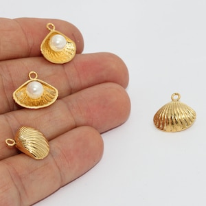 May include: Gold-colored seashell charms with a pearl accent. The charms are in various shapes, including open shells with pearls and closed shells. Each charm has a small loop for attaching to jewelry or other crafts.
