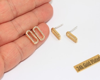 May include: Gold-plated rectangular stud earrings with clear crystals. The earrings are shown with a matching pair of open rectangle earrings with crystals. A small gold rectangle with the text "24k Gold Plated" is also visible.