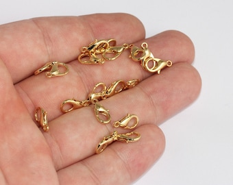 May include: A collection of small, shiny gold-colored lobster claw clasps. These clasps are designed for jewelry making and crafting, featuring a spring-loaded mechanism for secure closure. The clasps are shown against a neutral background.