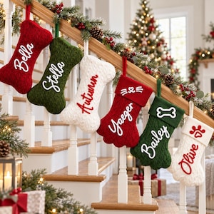 May include: Six personalized Christmas stockings in red, green, and white cable knit. Three are bone-shaped with names Bella, Stella, and Autumn. Three are paw-shaped with names Yaeger, Bailey, and Olive, featuring cat or dog-themed embroidery.