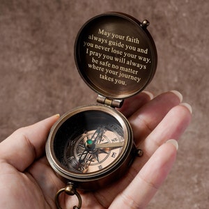 May include: A brass compass with a green jewel in the centre. The compass is open and the lid has an engraved message: "May your faith always guide you and you never lose your way. I pray you will always be safe no matter where your journey takes you."