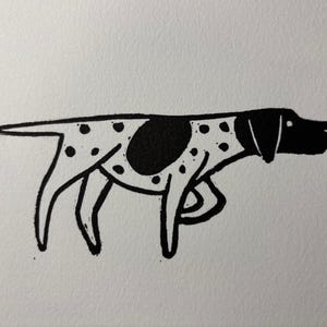 May include: A black and white illustration of a dog in profile. The dog has a black head, ears, and a large spot on its side. The dog's body is white with black spots. The artwork is simple and graphic.