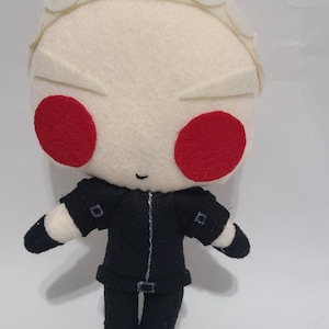 May include: A white felt plush toy with red eyes and a black felt outfit. The toy has a simple, cartoon-like design.