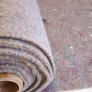 May include: A roll of brown felt padding material. The felt is tightly rolled and has a slightly textured surface.