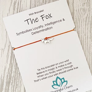 May include: Red string bracelet with a silver fox charm. The card reads "Wish Bracelet The Fox Symbolises Loyalty, Intelligence & Determination Tie this bracelet on your wrist Believe in magic & make a wish When you finally wear it through That's when your wish should come true Meaningful Charm www.meaningfulcharm.co.uk"