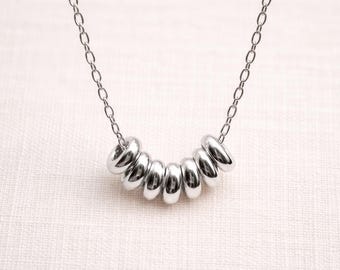 Sterling Silver Seven Rings Necklace | Minimalist Symbolic Jewelry